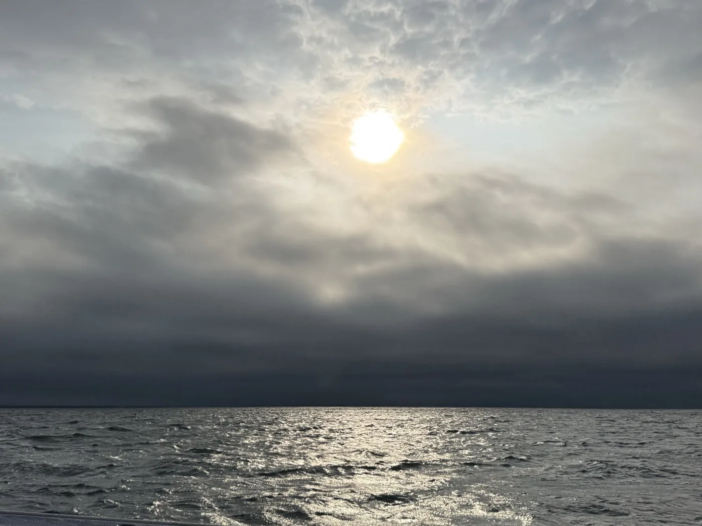Morning sun breaking through the clouds and a shining sea surface